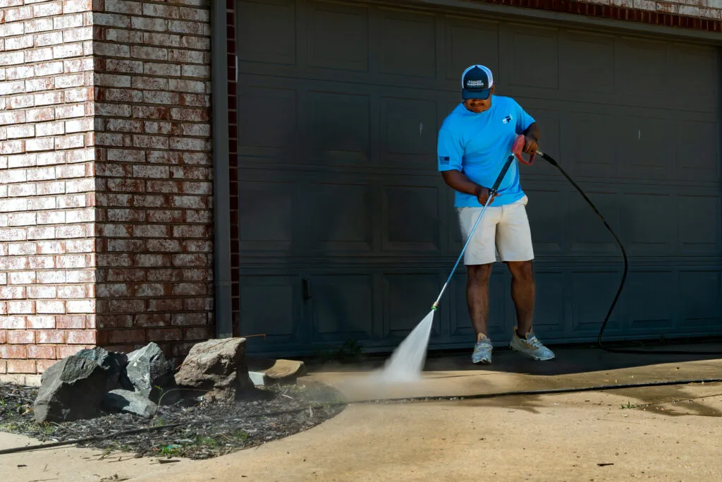 Power Washing of Tulsa cleaning driveway in front of garage door
